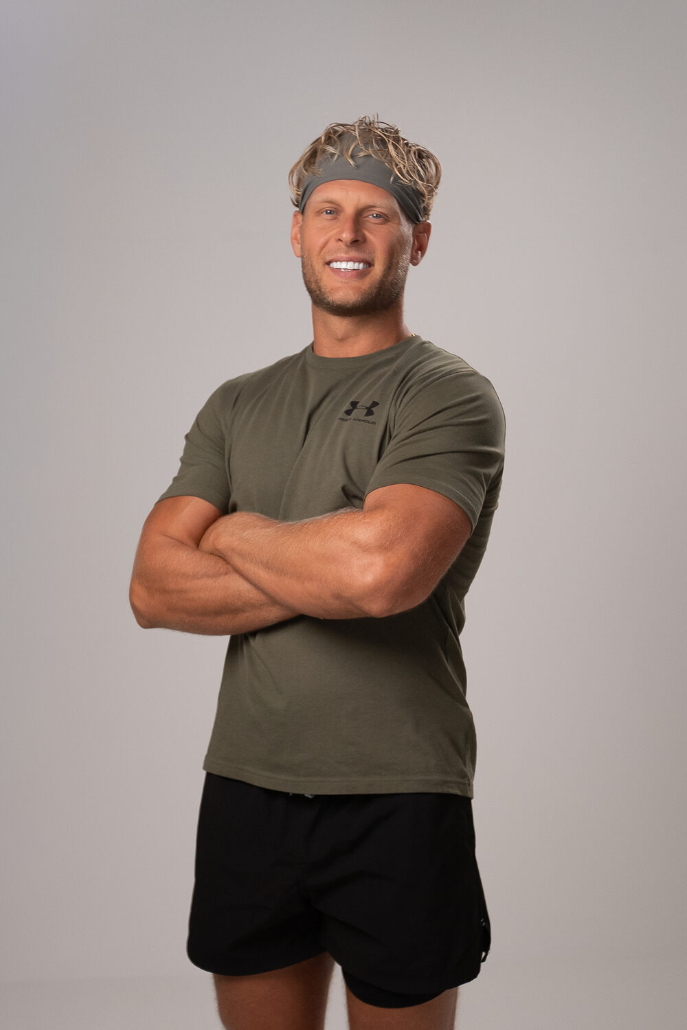 Kyle in a headband and olive t-shirt